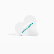 Load image into Gallery viewer, Heart-shaped white pillow with 'we love eyes' text on a white background