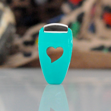 Load image into Gallery viewer, Turquoise bottle opener with heart design on a reflective surface, blurred background