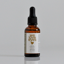 Load image into Gallery viewer, Bottle of 'we love eyes' eye serum with dropper on a gray background
