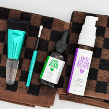 Load image into Gallery viewer, Set of 'we love eyes' skincare products on a checkered towel
