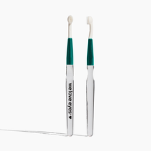 Load image into Gallery viewer, Two white toothbrushes with green bristle heads on a white background, featuring the brand 'we love eyes'.
