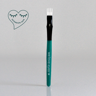 Eyebrow brush with green handle and black bristle head on a light gray background, featuring 'we love eyes' branding.