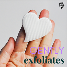 Load image into Gallery viewer, Heart-shaped white object held between fingers against a light gray background
