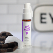 Load image into Gallery viewer, Bottle of 'we love eyes' eye cream with a blurred background
