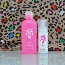 Load image into Gallery viewer, Two 'we love eyes' skincare products on a reflective surface with a colorful leopard print background.
