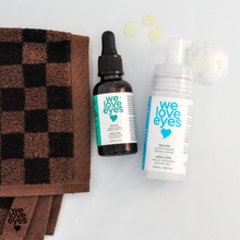 Load image into Gallery viewer, Two 'we love eyes' products on a white background with a checkered towel.
